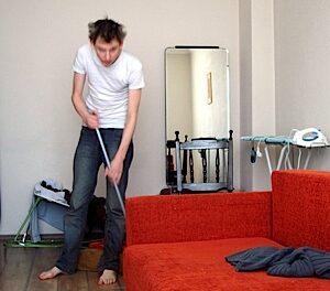 Tim cleans his flat
